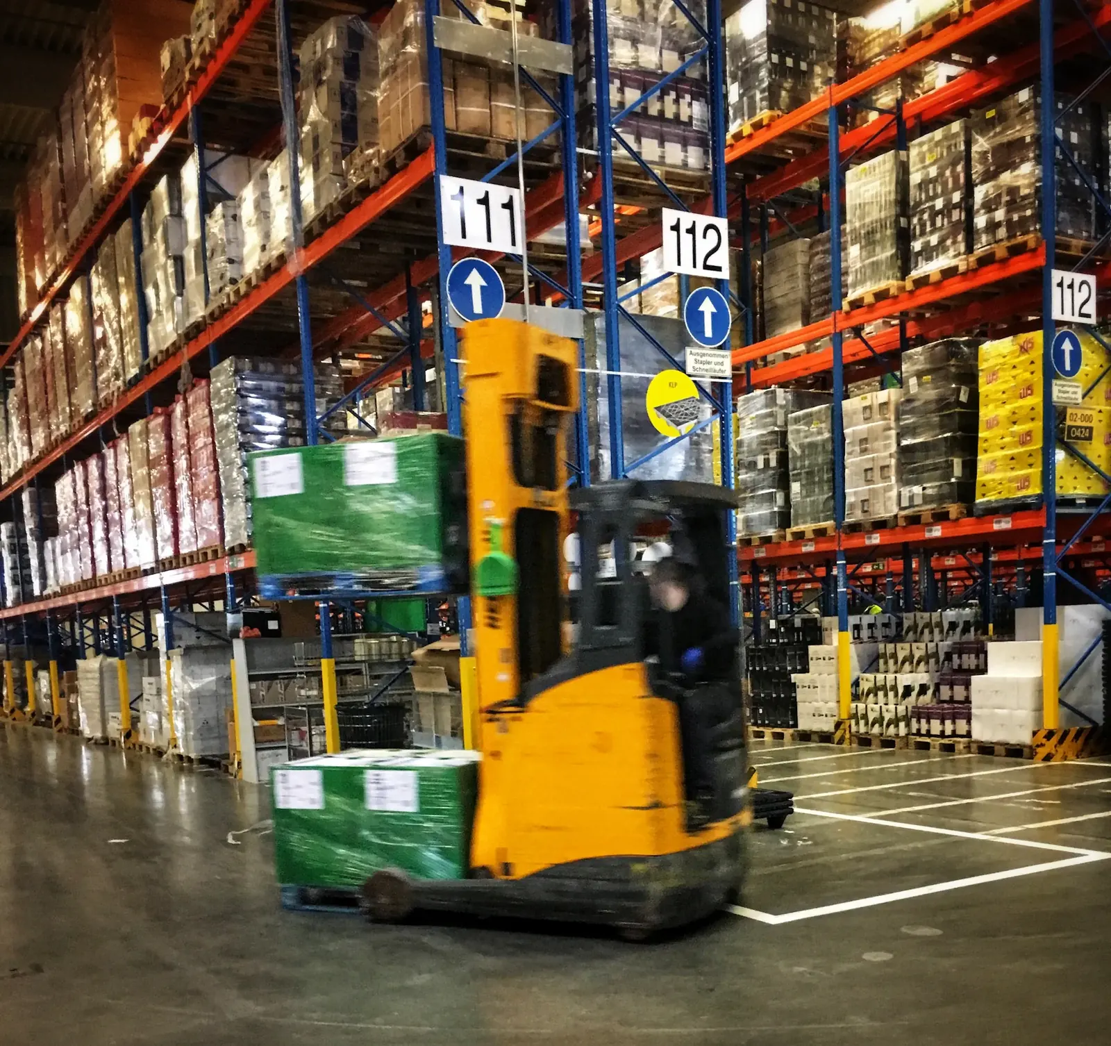 Forklift moving inbound pallets through a warehouse receiving area